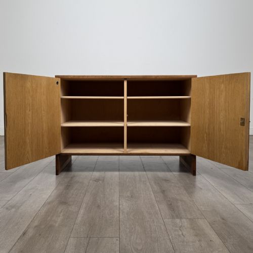 fig 1. A mid-century modern Danish oak cupboard featuring two flush panel doors and solid side supports.