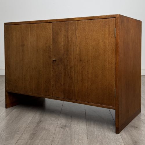 fig 2. A mid-century modern Danish oak cupboard featuring two flush panel doors and solid side supports.