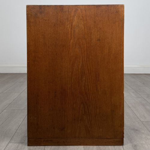 fig 3. A mid-century modern Danish oak cupboard featuring two flush panel doors and solid side supports.