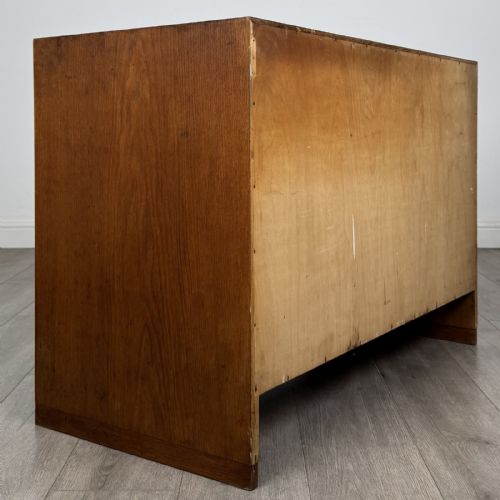 fig 4. A mid-century modern Danish oak cupboard featuring two flush panel doors and solid side supports.