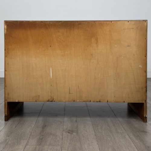 fig 5. A mid-century modern Danish oak cupboard featuring two flush panel doors and solid side supports.