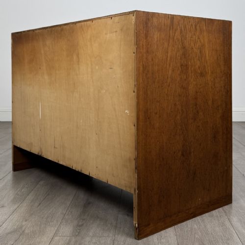 fig 6. A mid-century modern Danish oak cupboard featuring two flush panel doors and solid side supports.