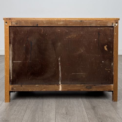 fig 4. A golden oak chest of drawers featuring three horizontal drawers with turned wooden knob handles resting on a shaped apron base.