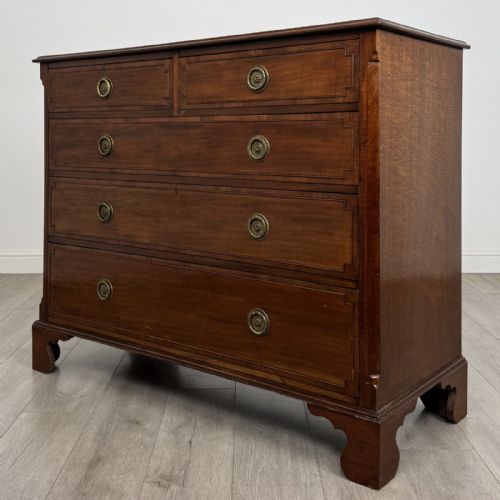 fig 1. A Georgian style mahogany chest of drawers featuring a two-over-three drawer arrangement, brass ring handles, and bracket feet.