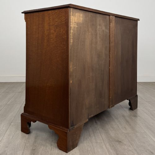 fig 3. A Georgian style mahogany chest of drawers featuring a two-over-three drawer arrangement, brass ring handles, and bracket feet.