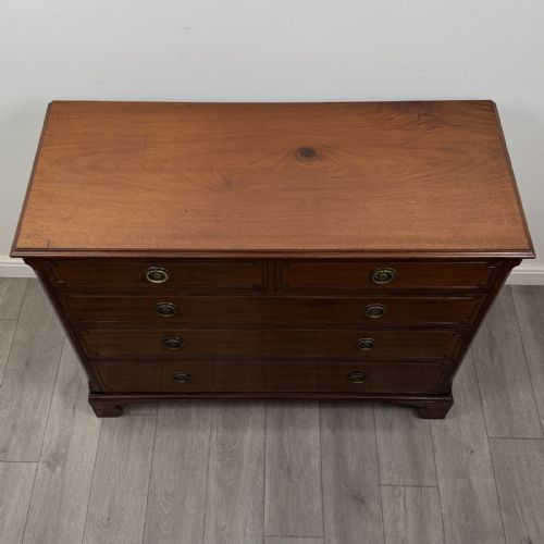 fig 8. A Georgian style mahogany chest of drawers featuring a two-over-three drawer arrangement, brass ring handles, and bracket feet.