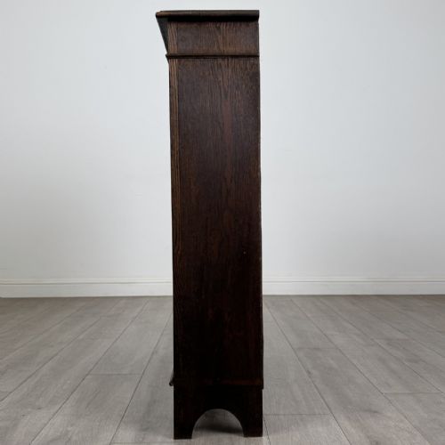 fig 3. A dark brown Victorian carved oak open bookcase with three adjustable shelves and carved decorative borders on the frieze and uprights.