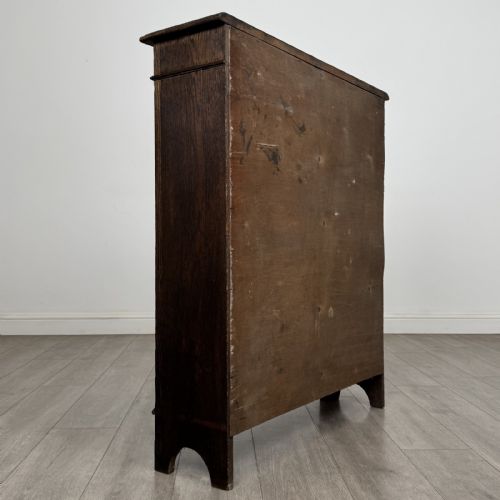 fig 4. A dark brown Victorian carved oak open bookcase with three adjustable shelves and carved decorative borders on the frieze and uprights.