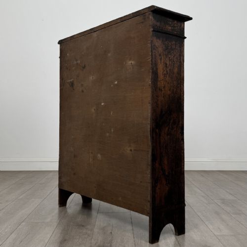 fig 6. A dark brown Victorian carved oak open bookcase with three adjustable shelves and carved decorative borders on the frieze and uprights.