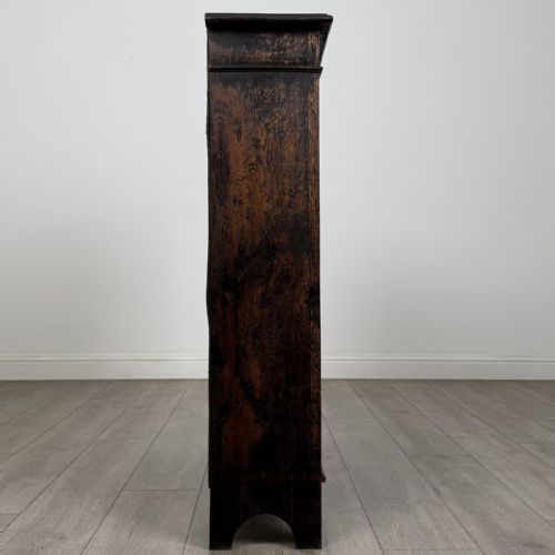 fig 7. A dark brown Victorian carved oak open bookcase with three adjustable shelves and carved decorative borders on the frieze and uprights.