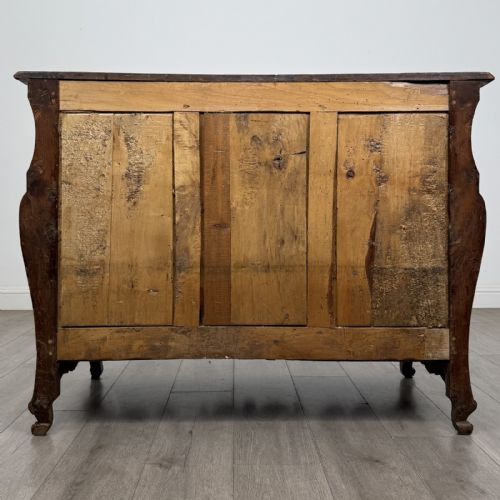 fig 4. An 18th-century French Louis XV bombe commode in warm brown cherrywood featuring ornate brass handles and cabriole legs.
