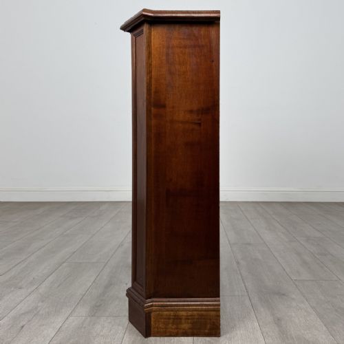 fig 3. An antique mahogany low open bookcase featuring canted corner posts, three tiers of open shelving, and a shaped bracket foot base.