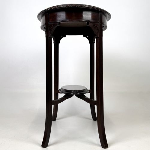fig 2. An Edwardian oval mahogany side table featuring a carved gadrooned top edge, pierced corner brackets, slender tapered legs, and a lower oval shelf.