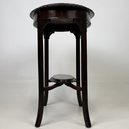 fig 6. An Edwardian oval mahogany side table featuring a carved gadrooned top edge, pierced corner brackets, slender tapered legs, and a lower oval shelf.