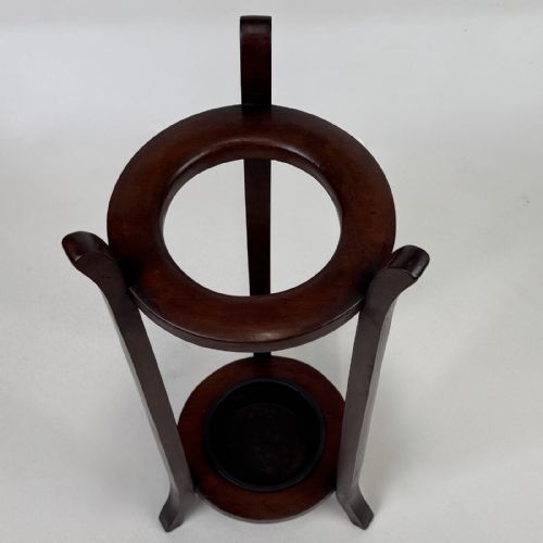 fig 4. A tall, dark mahogany three-legged umbrella stand featuring a circular top ring and a metal drip tray built into the lower ring base.