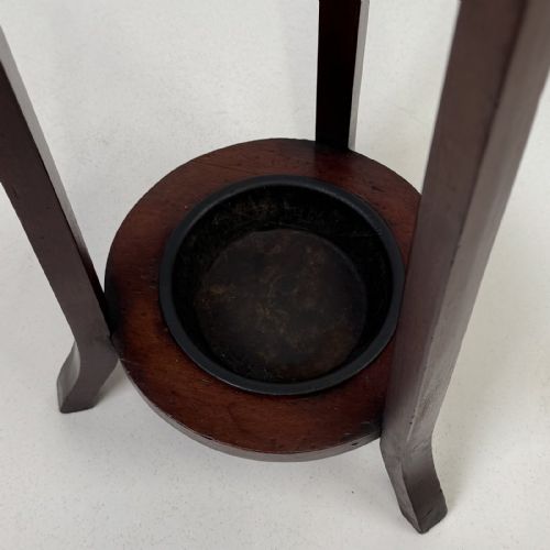 fig 5. A tall, dark mahogany three-legged umbrella stand featuring a circular top ring and a metal drip tray built into the lower ring base.
