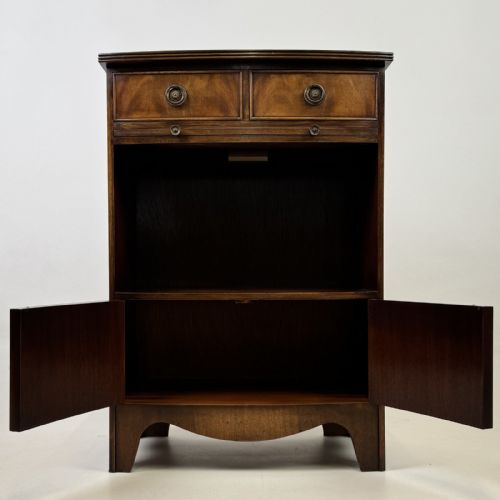 fig 1. A dark mahogany storage cabinet featuring top drawers, an extendable pull-out slide, an open alcove shelf, and a lower double door cupboard.