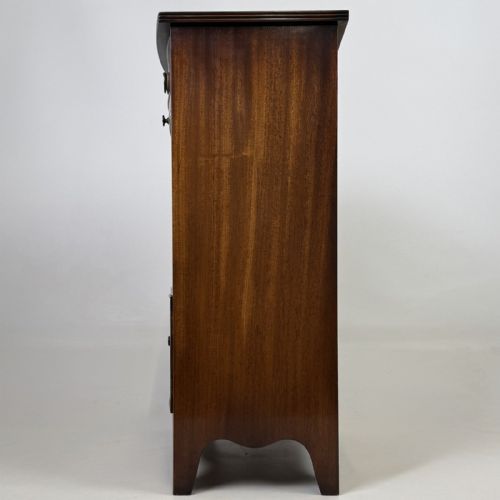 fig 2. A dark mahogany storage cabinet featuring top drawers, an extendable pull-out slide, an open alcove shelf, and a lower double door cupboard.