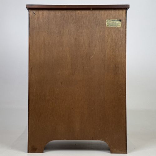 fig 4. A dark mahogany storage cabinet featuring top drawers, an extendable pull-out slide, an open alcove shelf, and a lower double door cupboard.