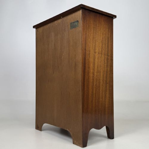fig 5. A dark mahogany storage cabinet featuring top drawers, an extendable pull-out slide, an open alcove shelf, and a lower double door cupboard.