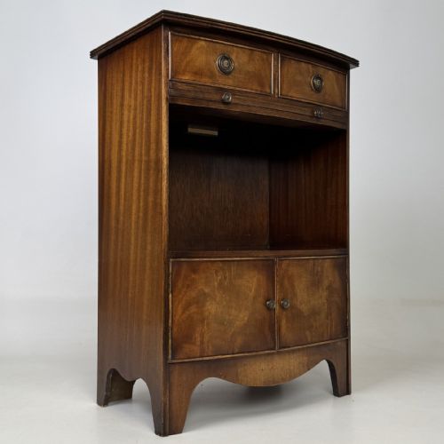 fig 7. A dark mahogany storage cabinet featuring top drawers, an extendable pull-out slide, an open alcove shelf, and a lower double door cupboard.