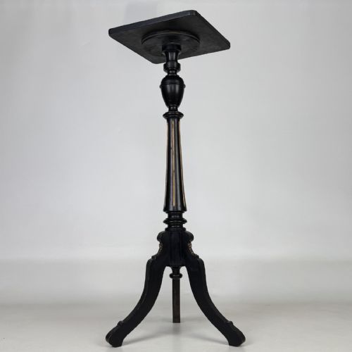 fig 1. A tall Victorian ebonised wooden plant stand featuring a square top, turned fluted column with gilt highlights, and a curved tripod base.