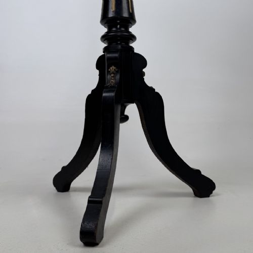 fig 6. A tall Victorian ebonised wooden plant stand featuring a square top, turned fluted column with gilt highlights, and a curved tripod base.