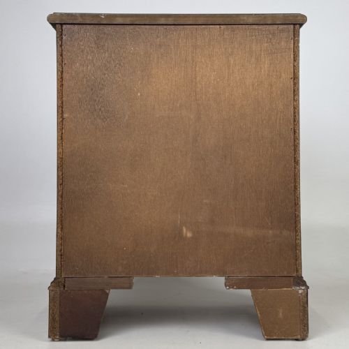 fig 4. A dark mahogany small chest of three drawers featuring brass ring pull handles and bracket feet.
