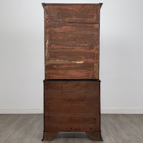 fig 5. A tall dark mahogany bookcase featuring a serpentine front profile, upper astragal glazed double doors, and a lower double-door cupboard.