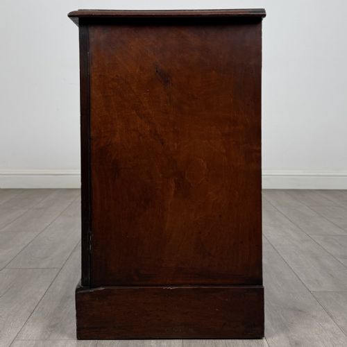fig 3. A Victorian mahogany collectors cabinet featuring flame mahogany twin panel doors and a wide plinth base.