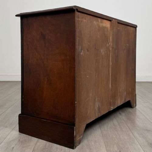 fig 4. A Victorian mahogany collectors cabinet featuring flame mahogany twin panel doors and a wide plinth base.