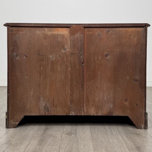 fig 5. A Victorian mahogany collectors cabinet featuring flame mahogany twin panel doors and a wide plinth base.