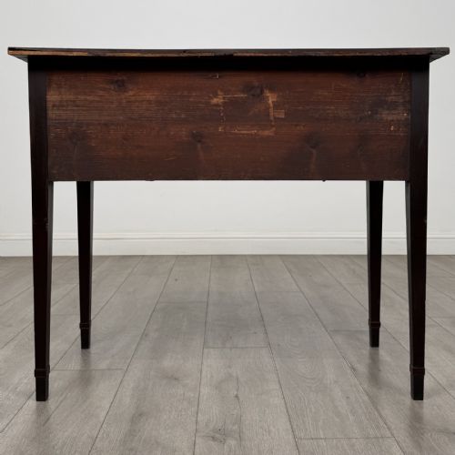 fig 4. An antique Georgian mahogany bow-front side table with flame mahogany inlaid drawers, brass ring handles, and tapered square legs.