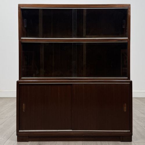 fig 1. A pair of dark mahogany display cabinets featuring sliding glass upper doors and solid wooden sliding lower doors.