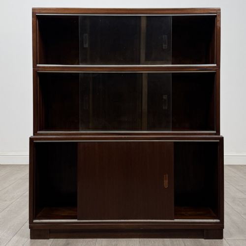 fig 2. A pair of dark mahogany display cabinets featuring sliding glass upper doors and solid wooden sliding lower doors.