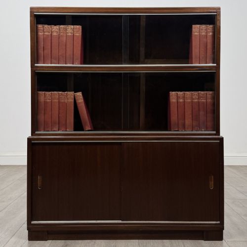 fig 3. A pair of dark mahogany display cabinets featuring sliding glass upper doors and solid wooden sliding lower doors.