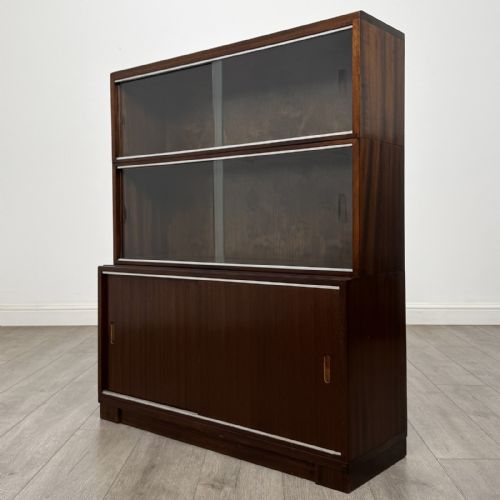 fig 4. A pair of dark mahogany display cabinets featuring sliding glass upper doors and solid wooden sliding lower doors.