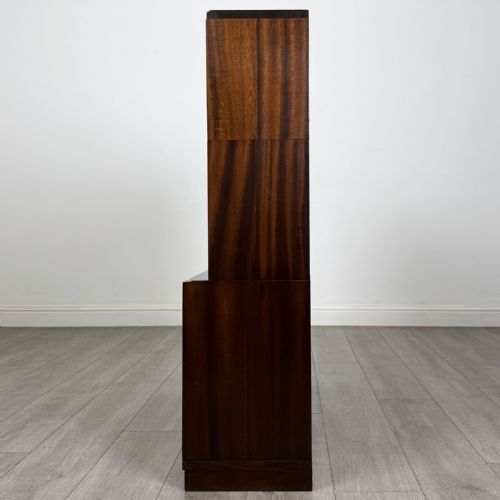 fig 5. A pair of dark mahogany display cabinets featuring sliding glass upper doors and solid wooden sliding lower doors.