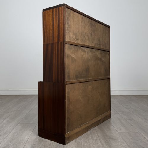 fig 6. A pair of dark mahogany display cabinets featuring sliding glass upper doors and solid wooden sliding lower doors.