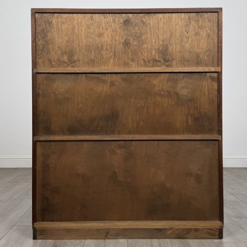 fig 7. A pair of dark mahogany display cabinets featuring sliding glass upper doors and solid wooden sliding lower doors.