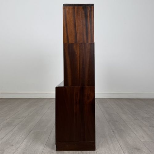 fig 4. A dark mahogany three-tier display cabinet featuring sliding glass doors and a rectangular plinth base.