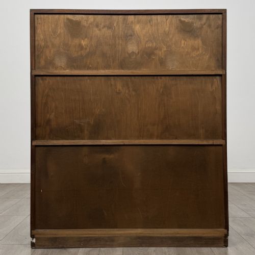 fig 6. A dark mahogany three-tier display cabinet featuring sliding glass doors and a rectangular plinth base.