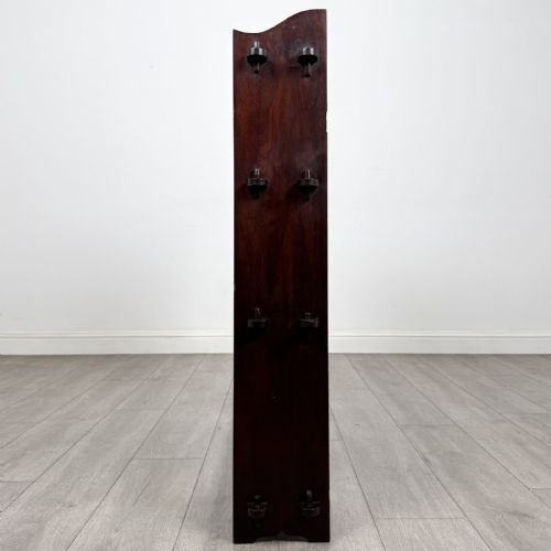 fig 3. A dark mahogany open bookcase featuring four tiered open shelves and a shaped, scalloped raised gallery back.