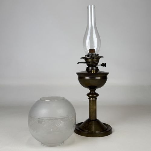 fig 3. An antique Victorian brass oil lamp featuring a circular stepped base, a columnar pedestal supporting a round brass reservoir, a burner assembly, a spherical etched frosted glass shade, and a clear glass chimney.