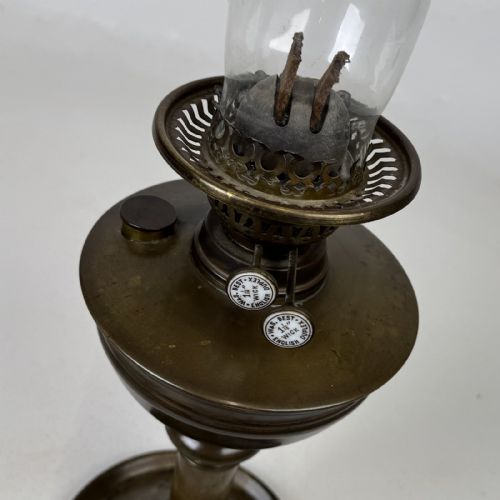fig 5. An antique Victorian brass oil lamp featuring a circular stepped base, a columnar pedestal supporting a round brass reservoir, a burner assembly, a spherical etched frosted glass shade, and a clear glass chimney.