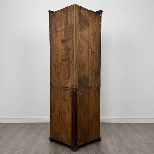 fig 2. An 18th-century Georgian mahogany standing corner cabinet featuring an upper astragal glazed door and a lower solid panel door with oval inlay.