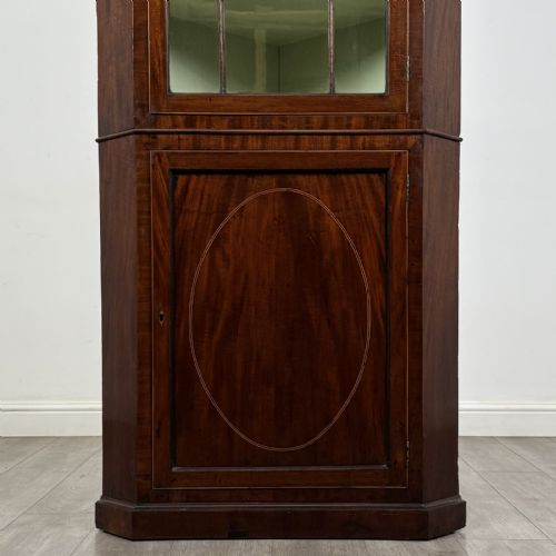 fig 4. An 18th-century Georgian mahogany standing corner cabinet featuring an upper astragal glazed door and a lower solid panel door with oval inlay.