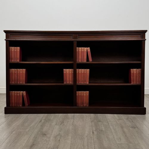 fig 1. A large 20th-century dark mahogany open bookcase featuring two wide bays with adjustable shelving and a solid plinth base.