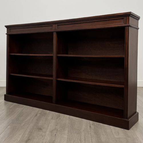 fig 2. A large 20th-century dark mahogany open bookcase featuring two wide bays with adjustable shelving and a solid plinth base.