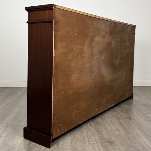 fig 4. A large 20th-century dark mahogany open bookcase featuring two wide bays with adjustable shelving and a solid plinth base.